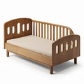 **Compact Wooden Toddler Bed with Safety Rail and Oval Cutouts**